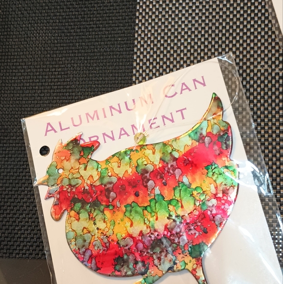 These painted ornaments are recycled tin cans. - Picture 2 of 3